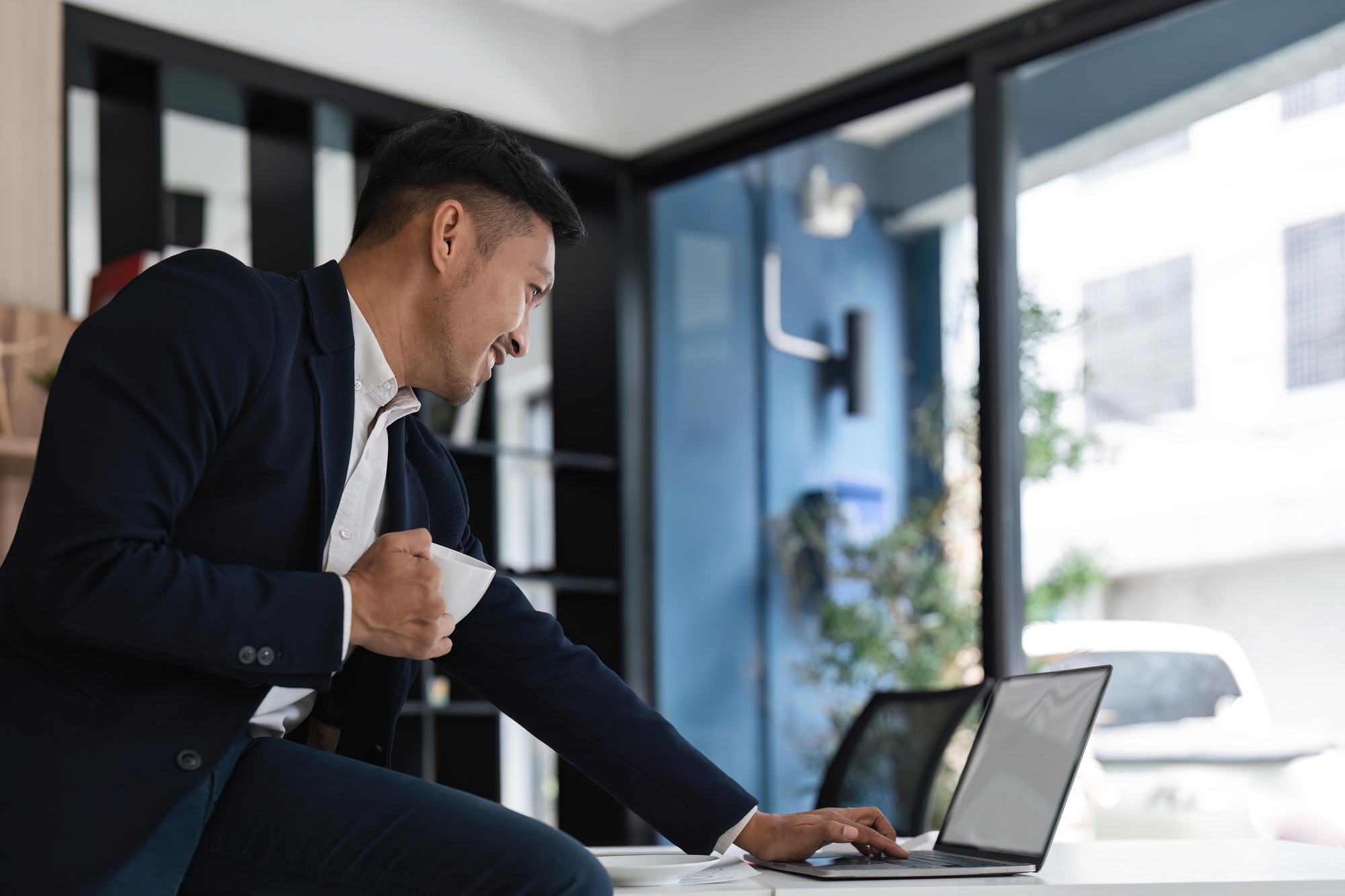 Businessman smile work with laptop screen for an email communication in an office